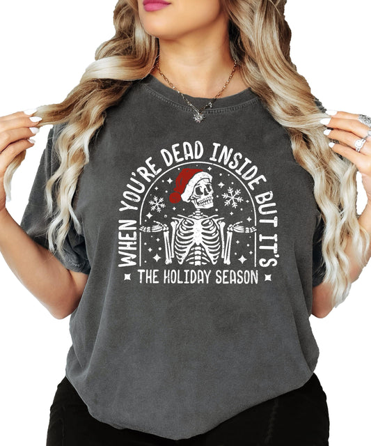 Funny Christmas skeleton tee with snowflakes and holiday text on seafoam colored shirt