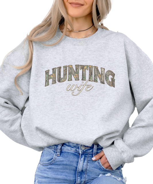 Close-up of camouflage hunting wife graphic print on women's green sweatshirt
