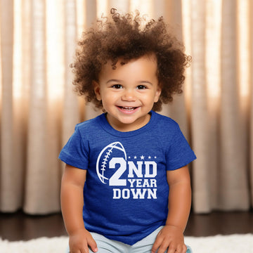 Toddler boy modeling second birthday football outfit shirt in black by Olive Loves Apple