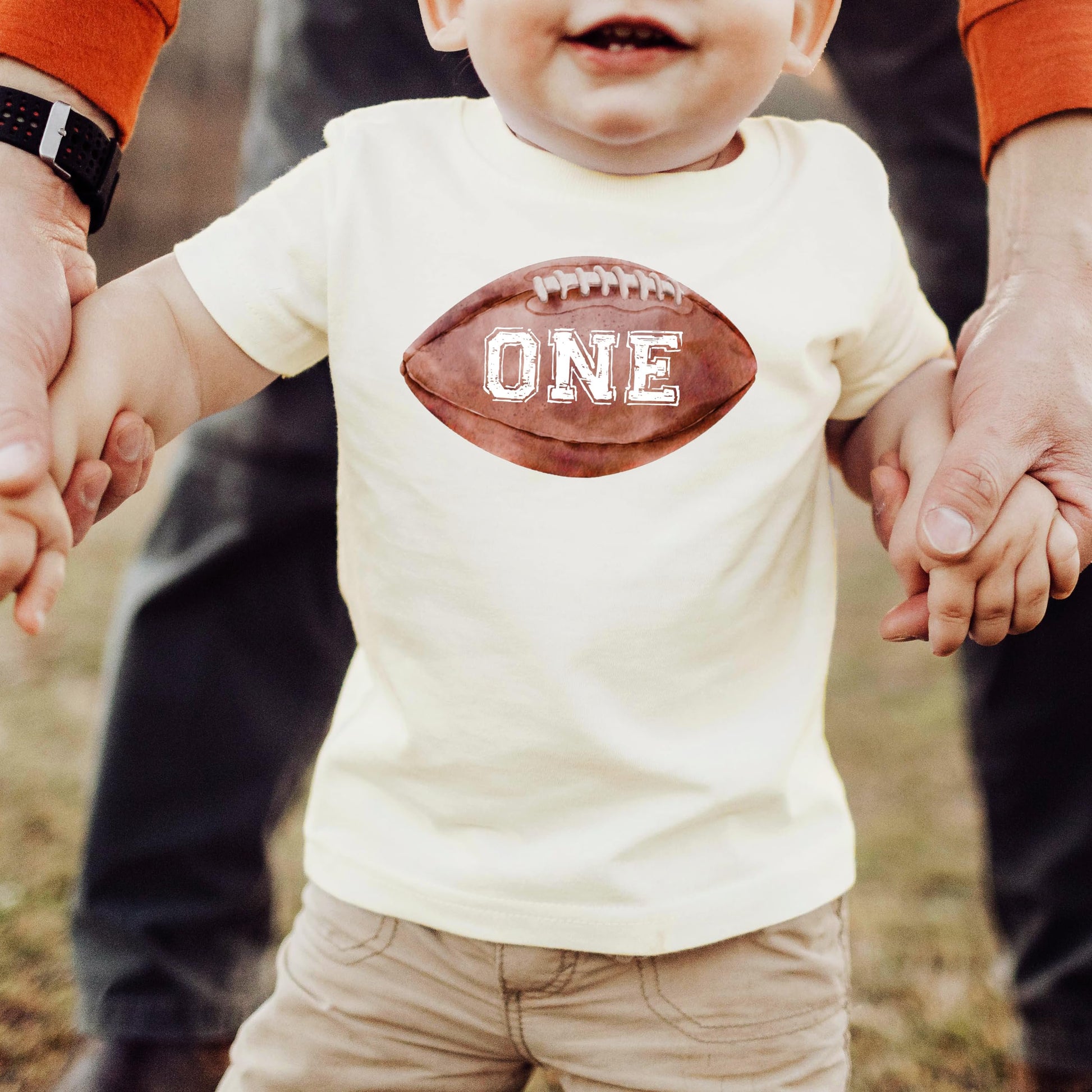Detail shot of distressed number one sports graphic on baby birthday shirt