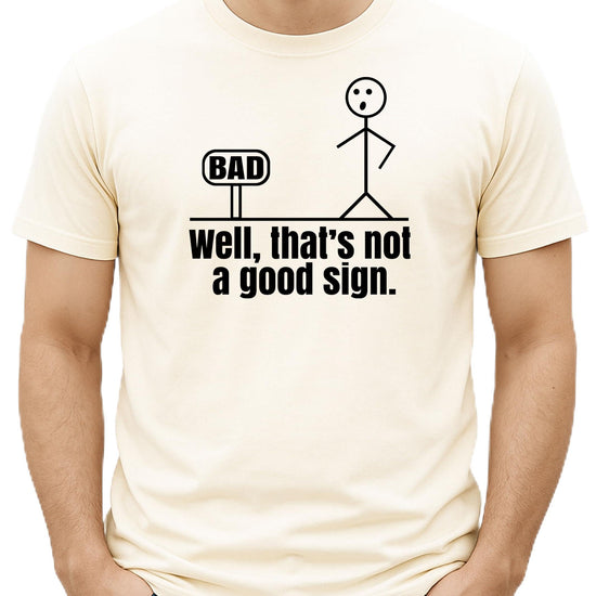 Close-up view of stick figure bad sign humor graphic print on men's t-shirt