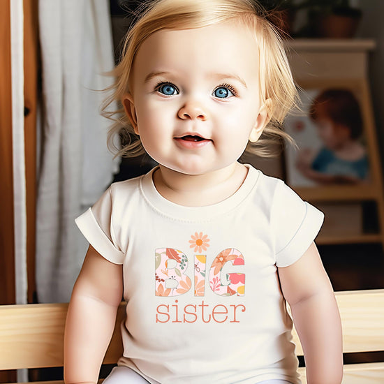 Detail shot of vibrant daisy floral print on a Big Sister youth graphic tee