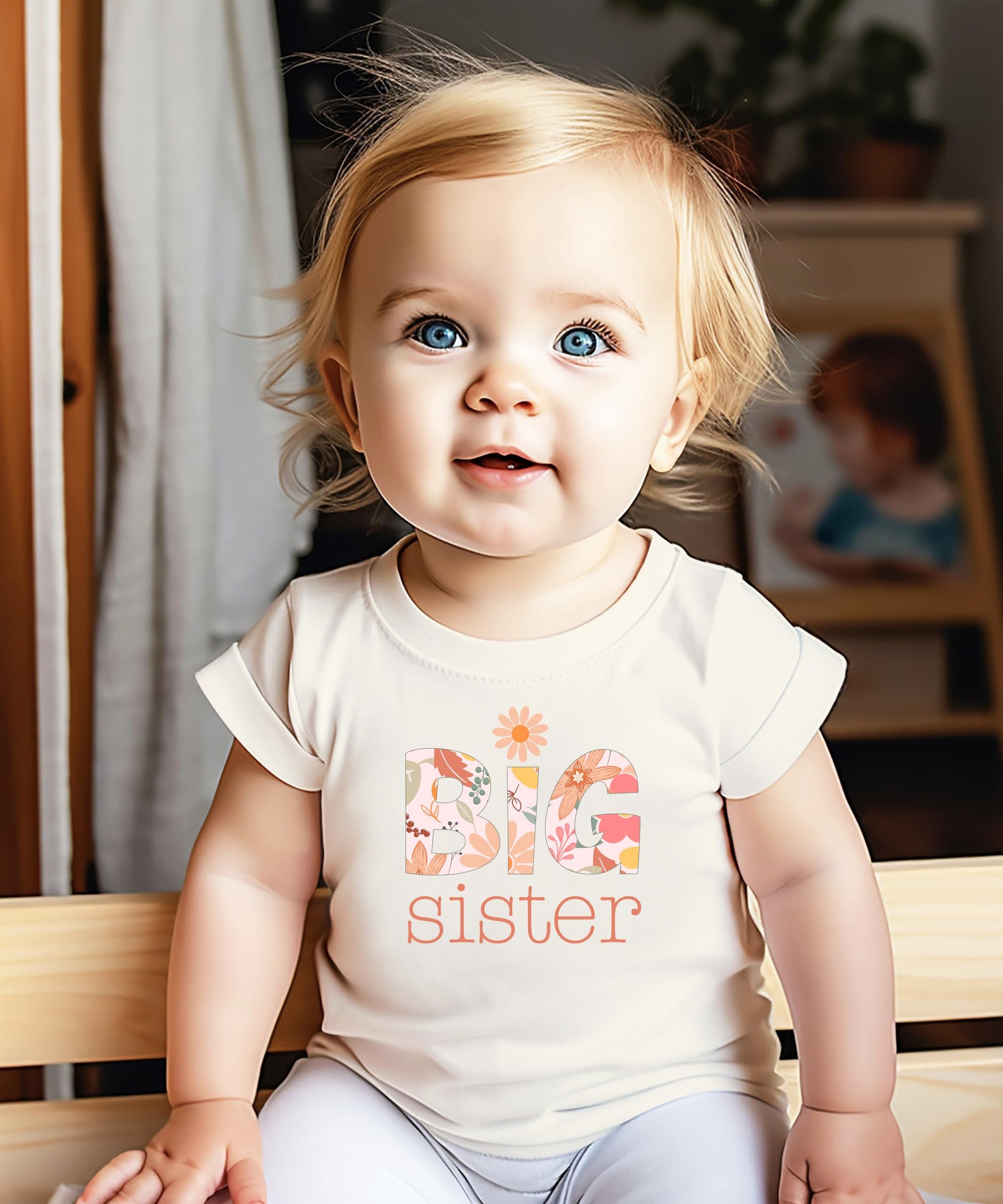 Detail shot of vibrant daisy floral print on a Big Sister youth graphic tee