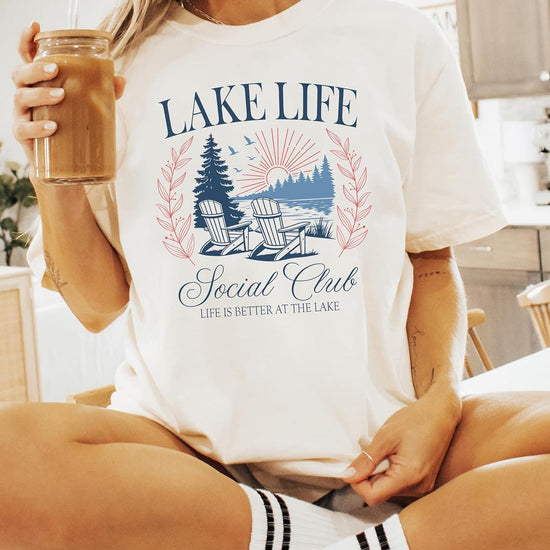 Lake Life Social Club tee product shot displaying vintage lakeside graphics and Life Is Better At The Lake text