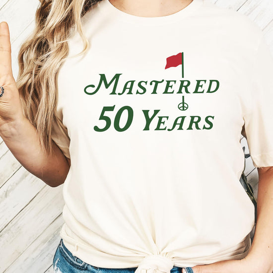 Close-up of vibrant golf-themed print on the Mastered 50 Years birthday shirt