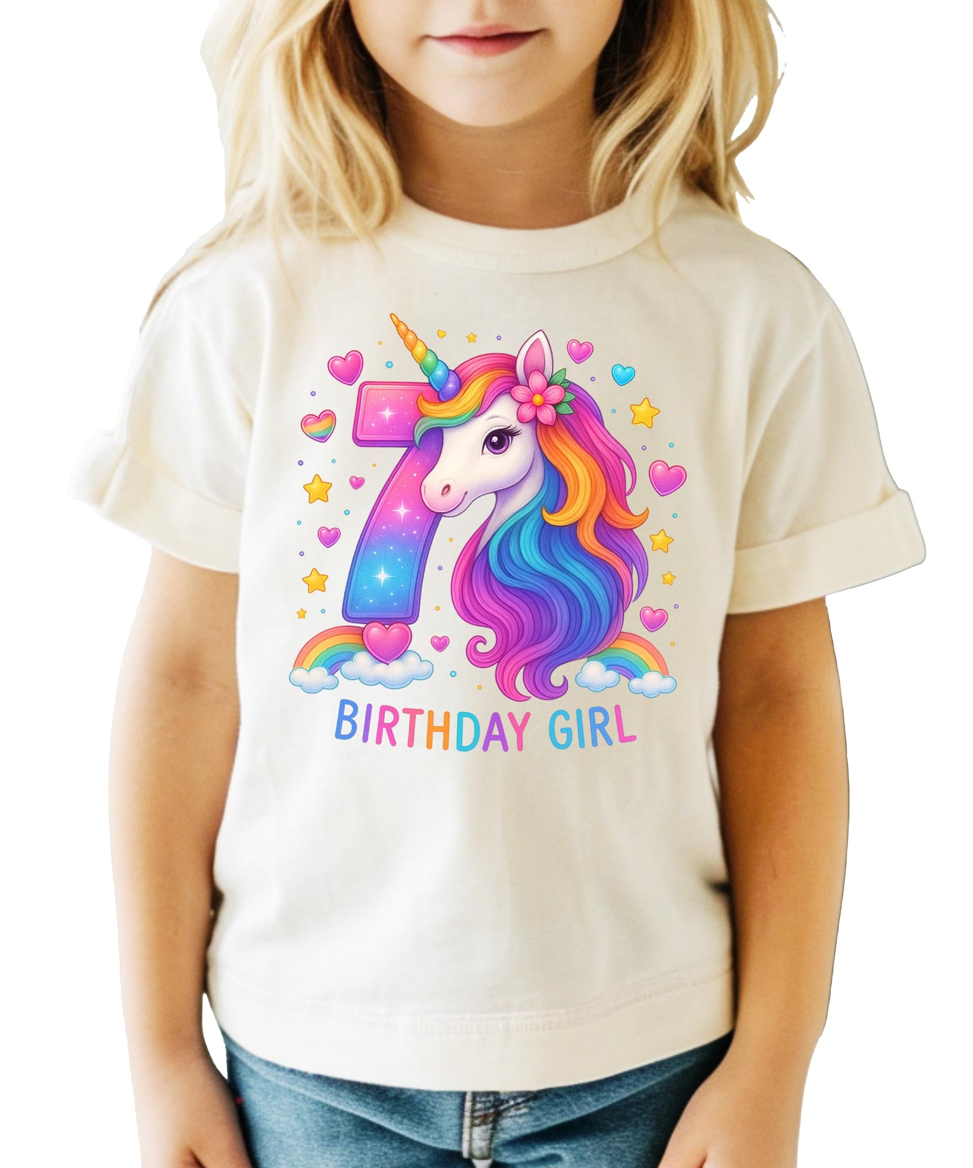 Flat lay of pink girls unicorn birthday tee showing rainbow horse graphic and number 7