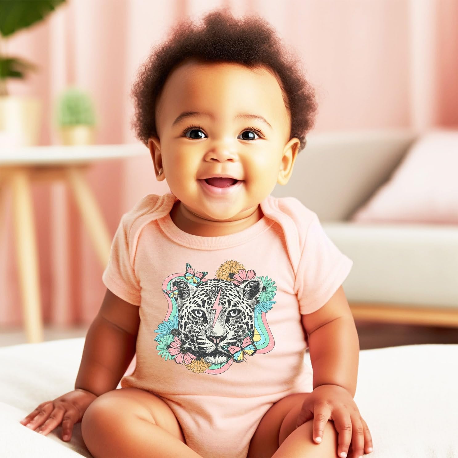 Detail shot of vibrant leopard and flowers graphic print on girls peach shirt or bodysuit