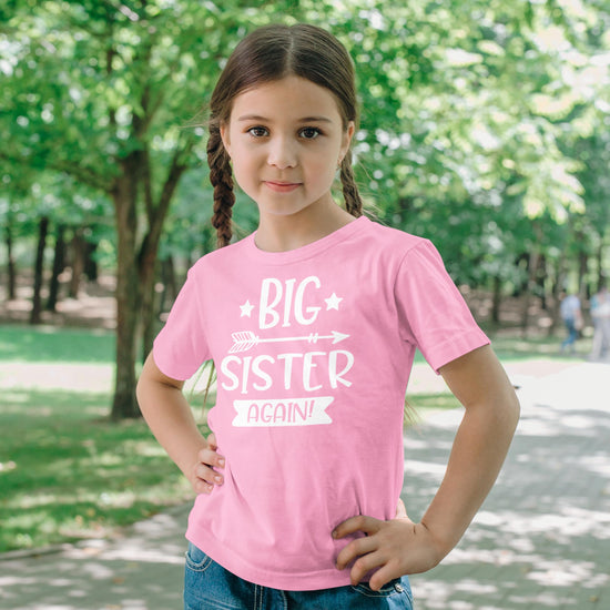 Side view of mauve Big Sister Again toddler tee for sibling announcement photos