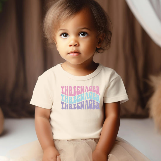 Flat lay of natural color groovy Threenager toddler birthday shirt showing full graphic