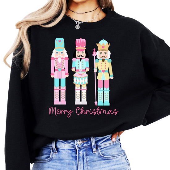 Black Christmas sweatshirt featuring whimsical pastel nutcracker and festive holiday text