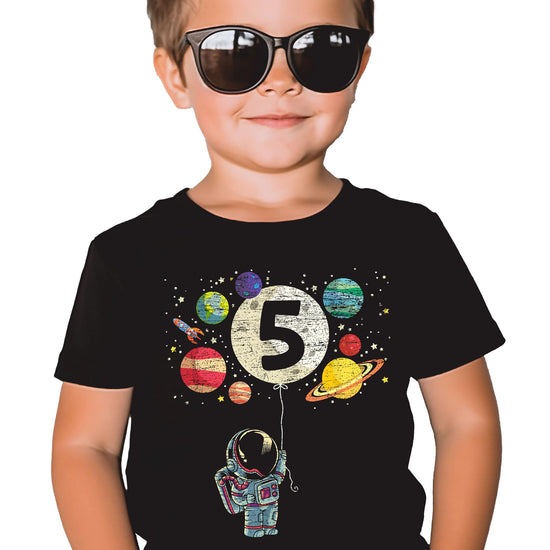 Flat lay of kids astronaut birthday shirt showing full rocket and planet design