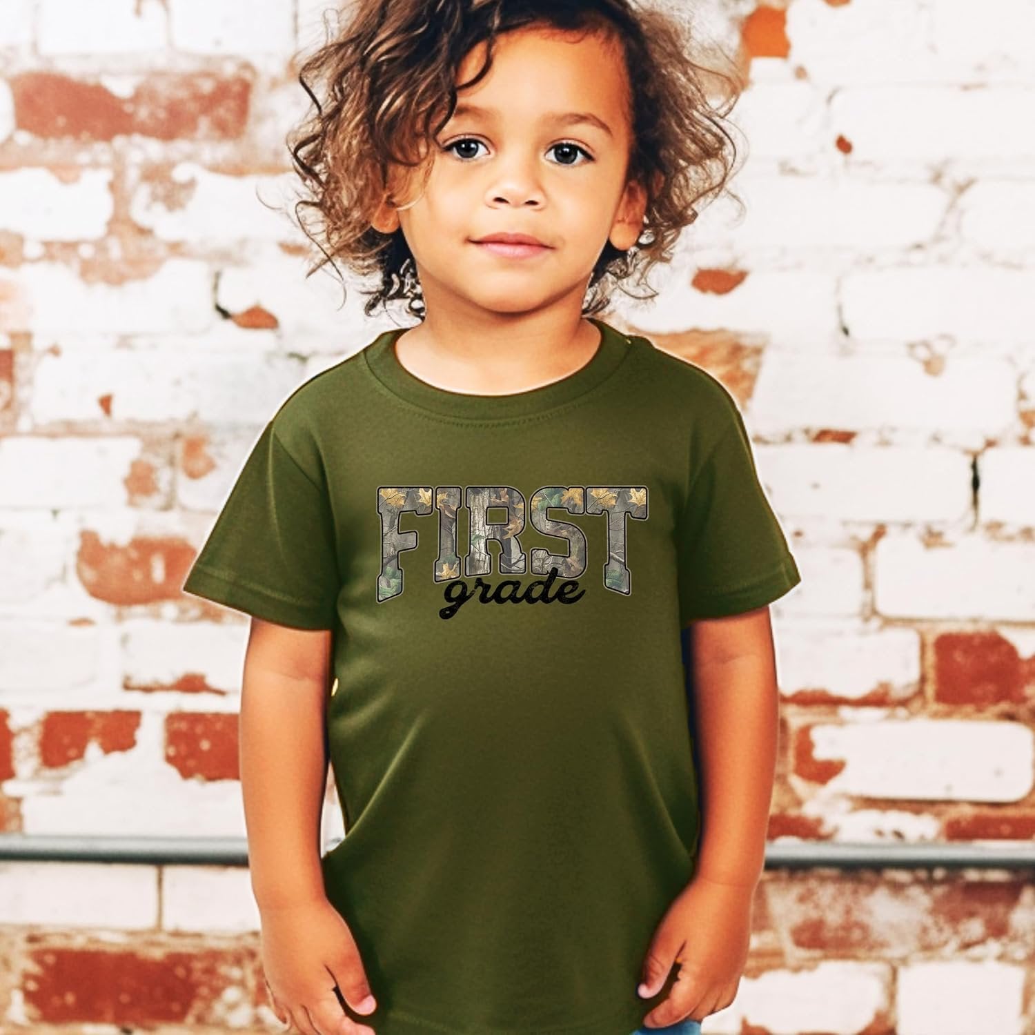 Close-up of First Grade camo print graphic on kids cotton tee by Olive Loves Apple