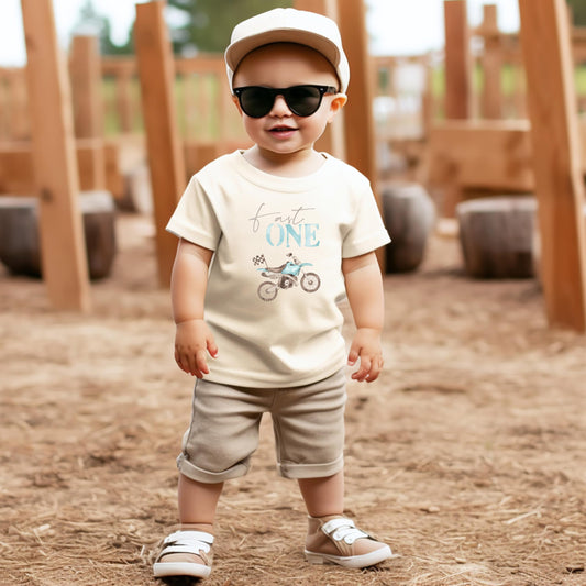 Front view of Fast One dirt bike birthday shirt for baby boys in natural color