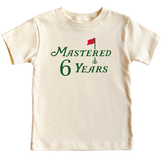 Child wearing natural colored sixth birthday golf themed graphic tee
