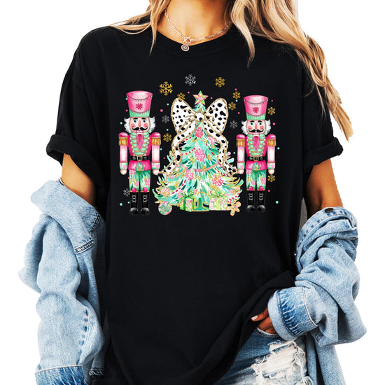Detail shot of professional printed nutcracker Christmas tree design on peach holiday t-shirt