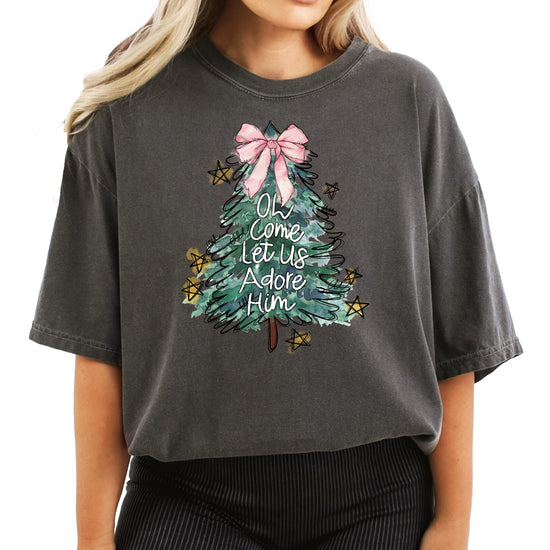 Women's seafoam Christmas graphic tee with religious holiday message and festive tree design