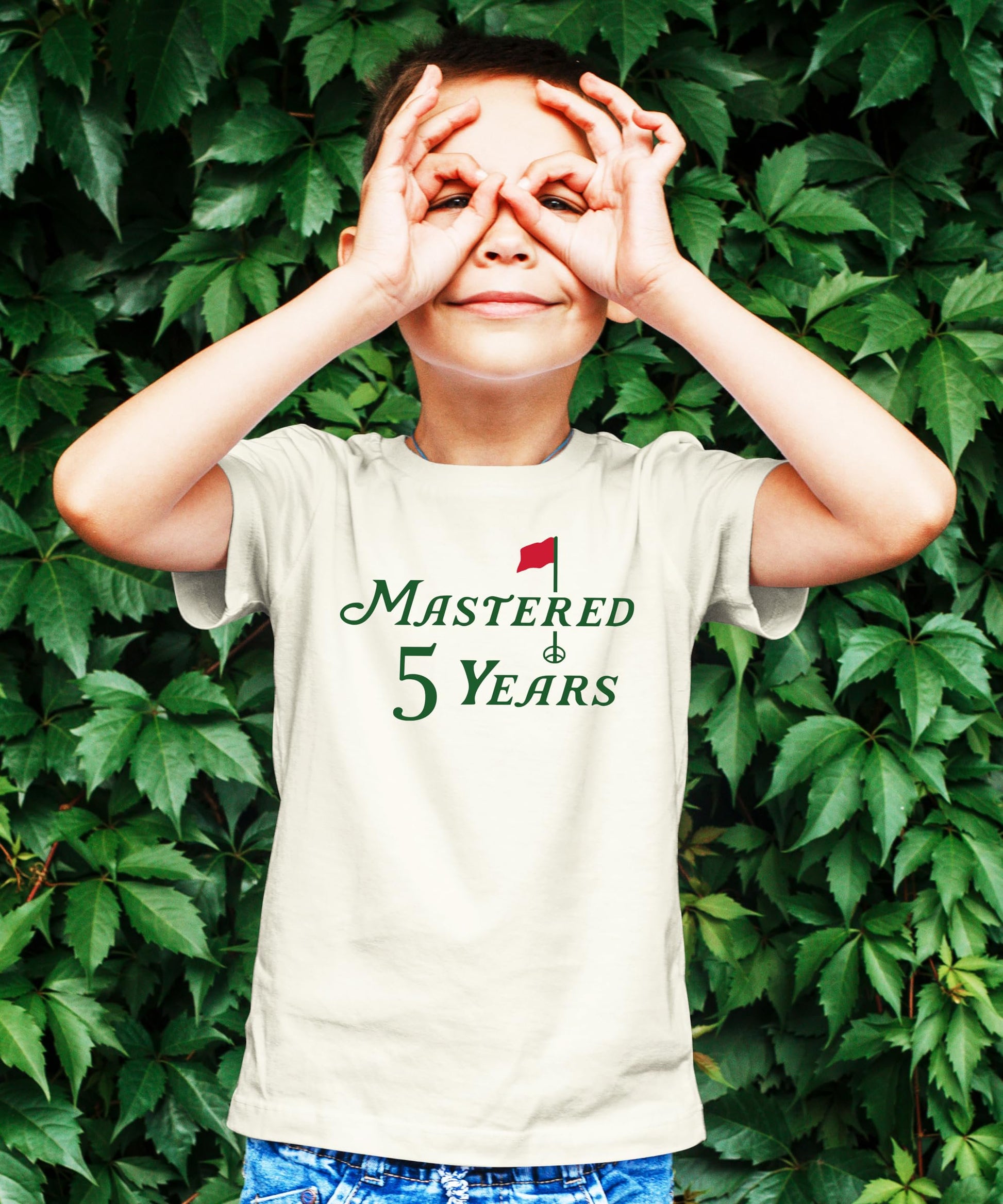 Close-up of Mastered 5 Years golf birthday graphic print on kids natural tee