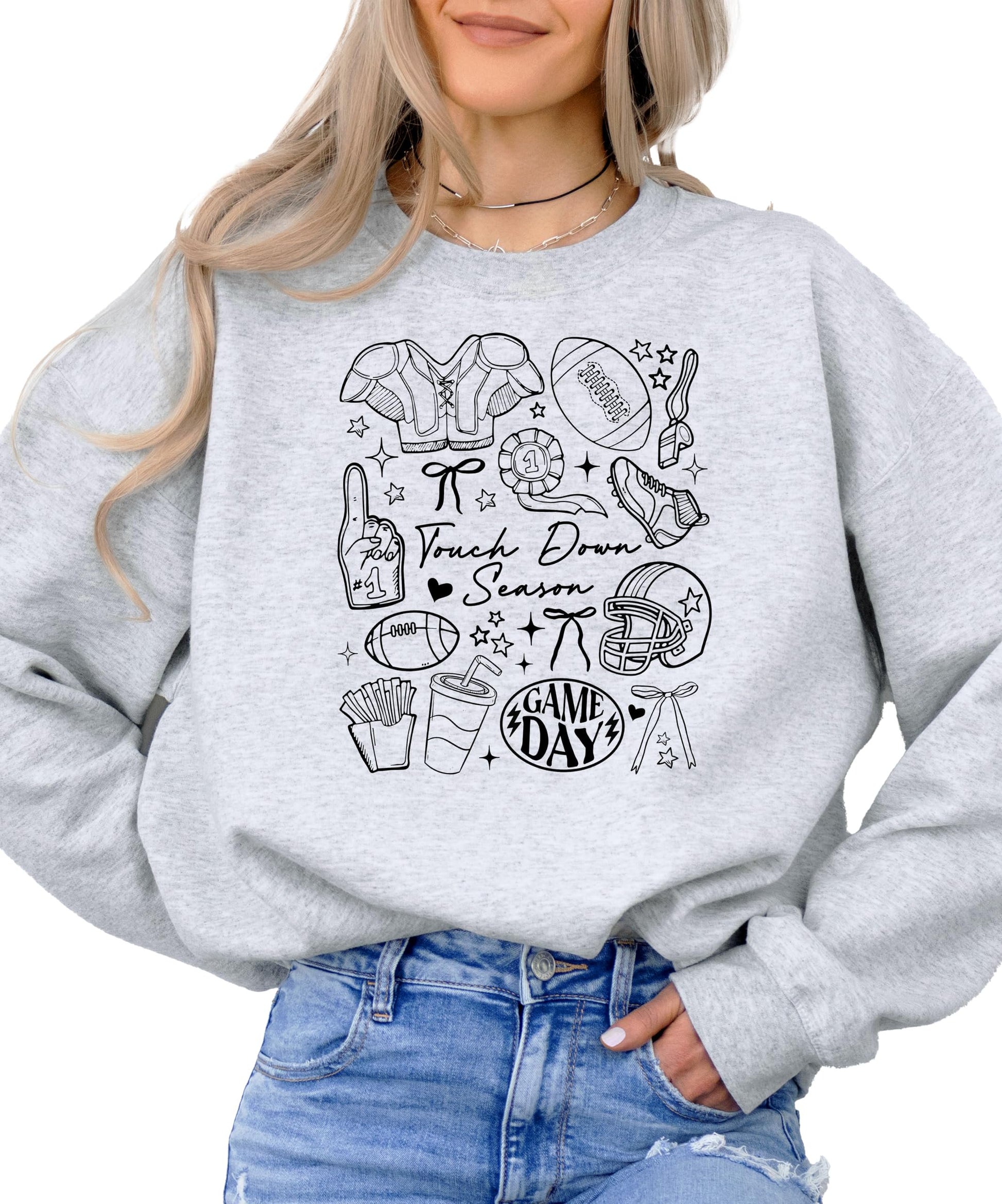 Woman wearing gray Touch Down Season football sweatshirt showing relaxed fit and style