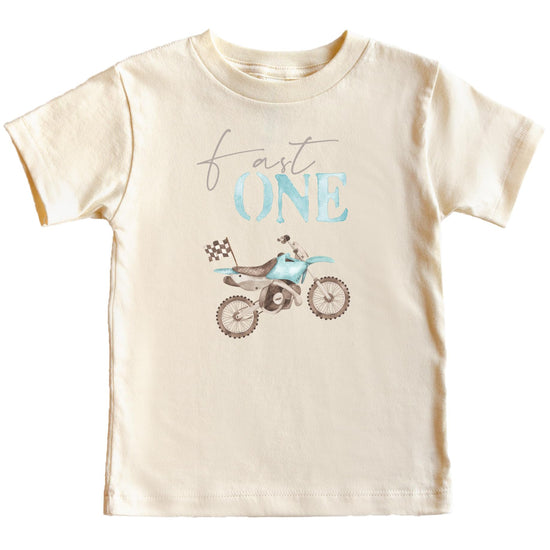 Natural toddler tee with blue dirt bike graphic and checkered flag reading One for boys first birthday