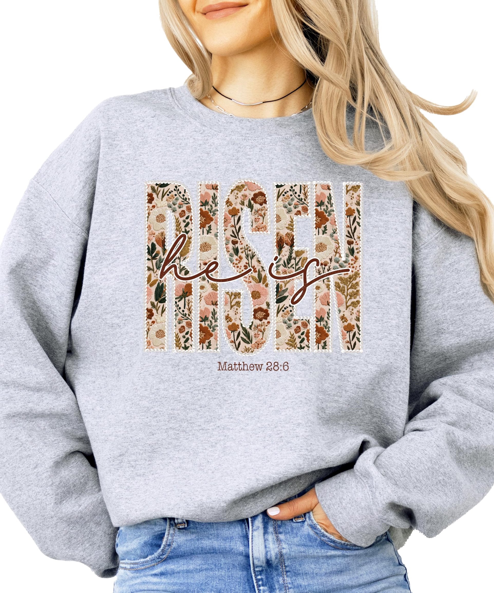 Close-up of ink-printed pearls and floral Easter design on women's faith sweatshirt