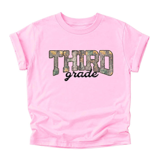 Girl wearing third grade camo tee in pink — fun back-to-school graphic shirt for kids