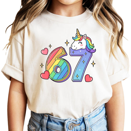 I Was 6 Now I'm 7 unicorn birthday shirt with rainbow numbers and sparkly unicorn graphic on natural shirt