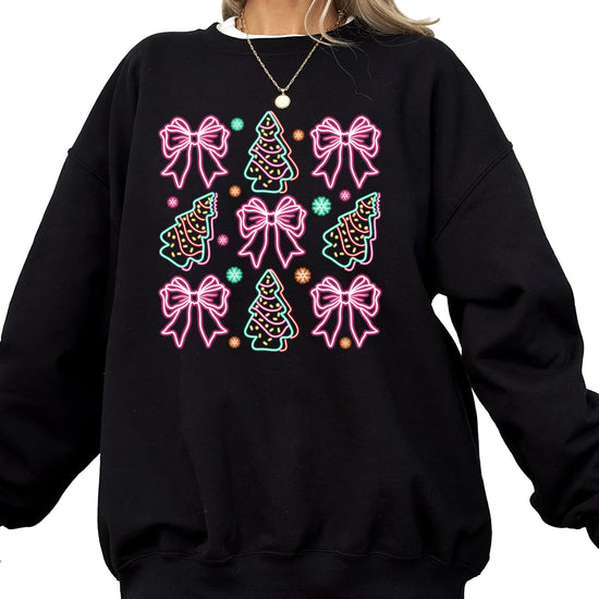 Black women's pullover sweatshirt with electric neon bows, Christmas trees, and snowflakes graphic design