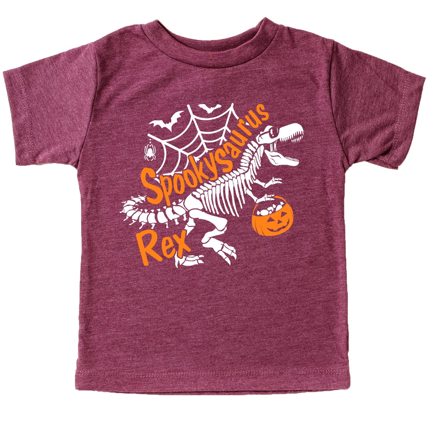 Close-up of skeleton dinosaur graphic on kids Halloween tee — bold white print on burgundy