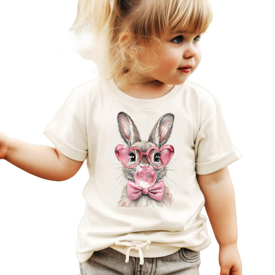 Close-up of bubblegum bunny print with bow and heart glasses on girls Easter shirt