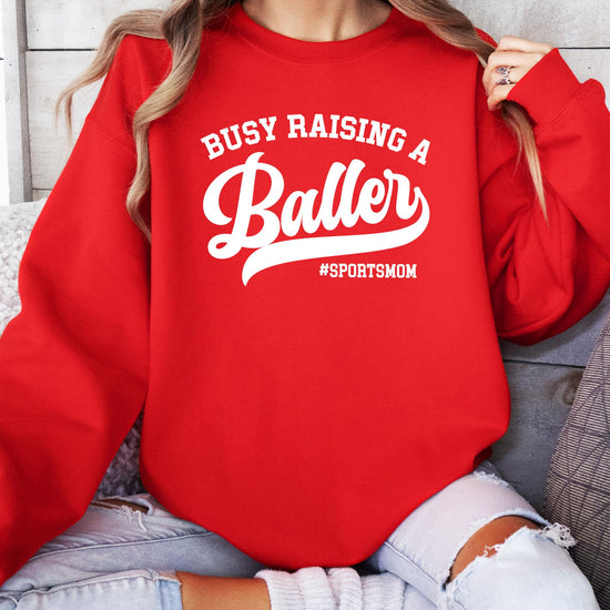 Side or folded view of Busy Raising a Baller women's sweatshirt showing fabric and fit