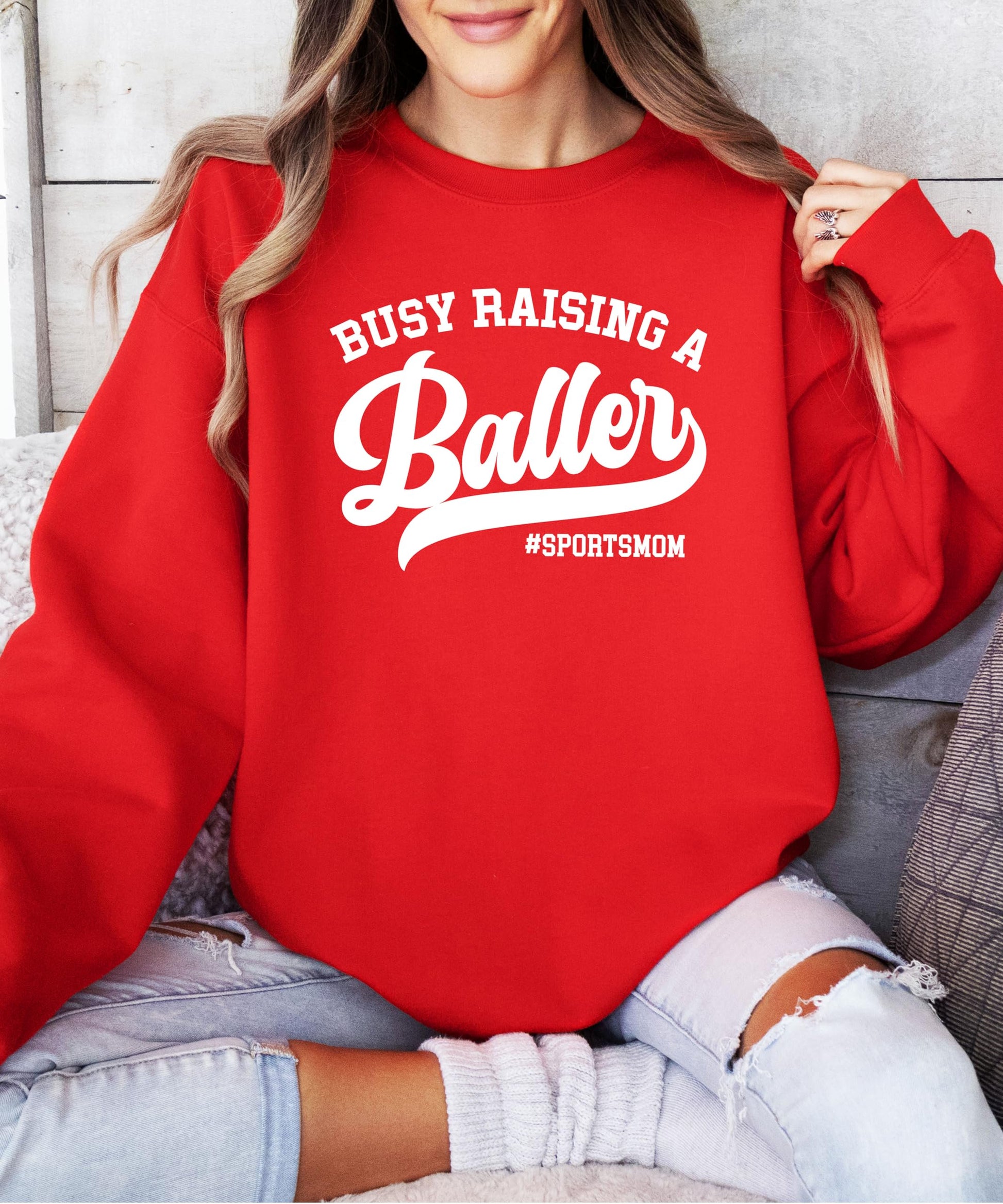 Side or folded view of Busy Raising a Baller women's sweatshirt showing fabric and fit