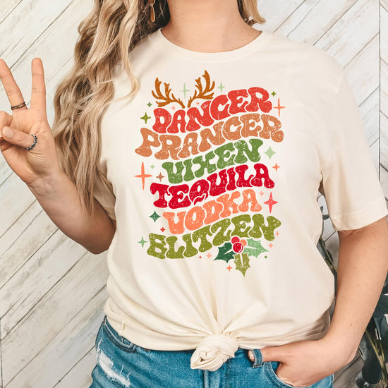 Adult wearing funny reindeer names Christmas tee at holiday party
