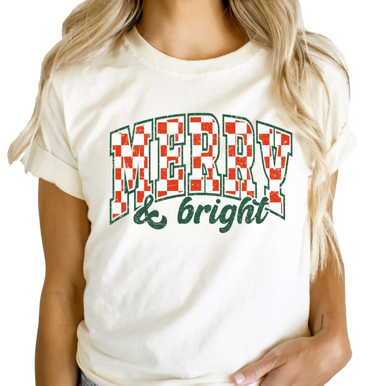 Kids wearing Merry and Bright peach Christmas graphic tee for holiday family photo