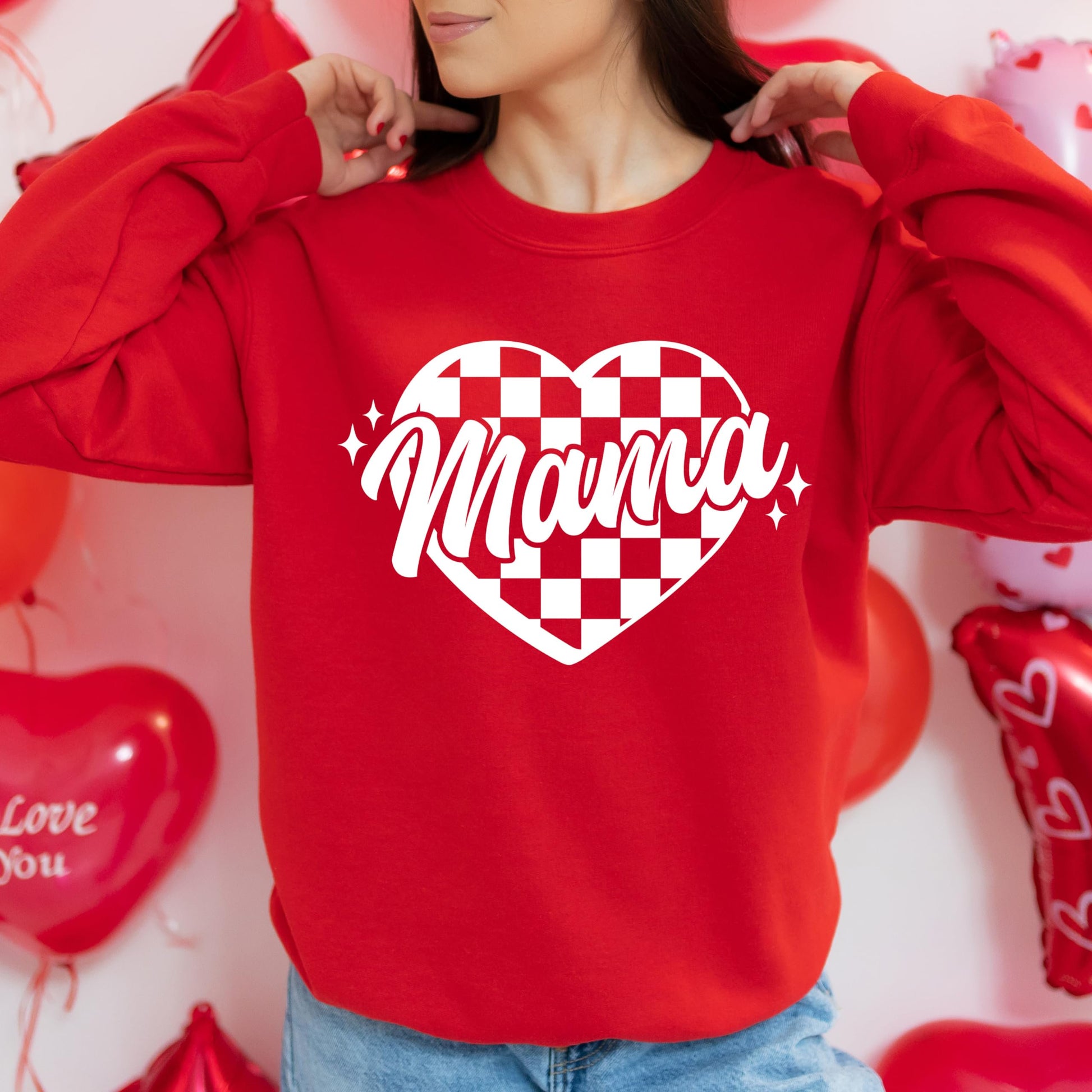 Close-up of checkered heart graphic print on red Valentine's Day sweatshirt
