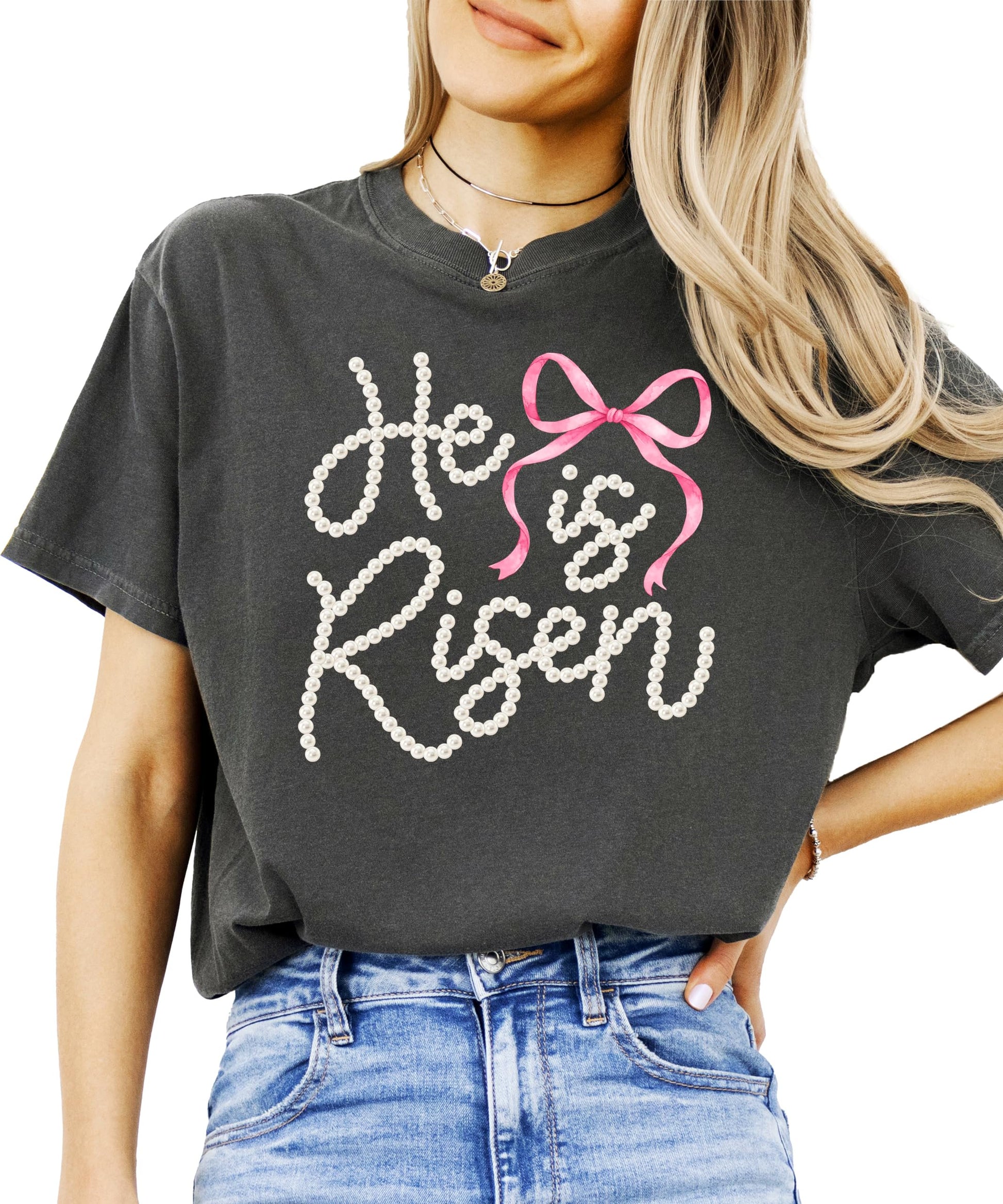 Flat lay of He Is Risen women's Christian t-shirt with coquette bow and resurrection message