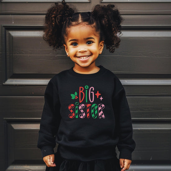 Side or lifestyle view of kids Big Sister candy cane holiday sweatshirt for sibling matching sets