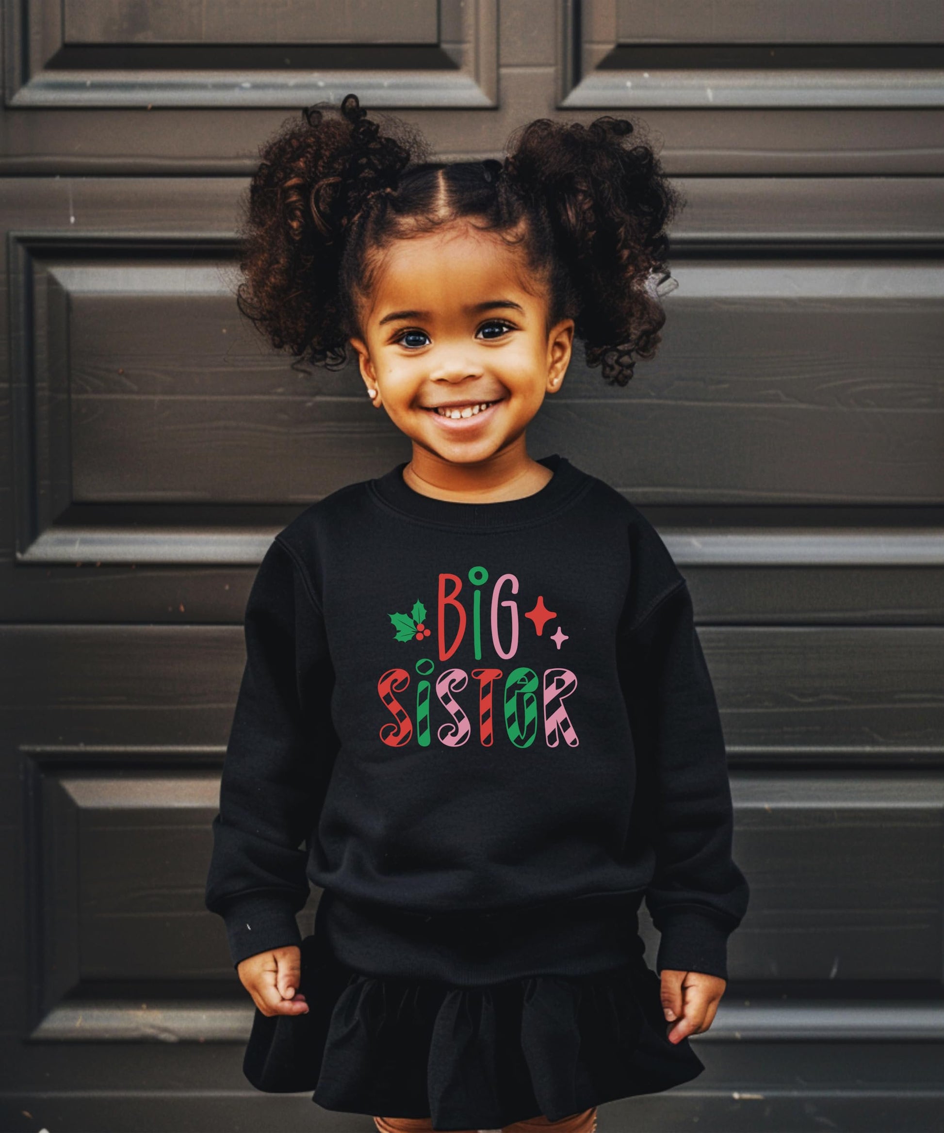 Side or lifestyle view of kids Big Sister candy cane holiday sweatshirt for sibling matching sets
