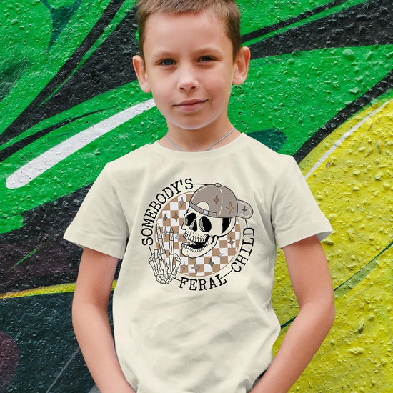Close-up of bold retro skeleton peace sign graphic print on natural kids t-shirt