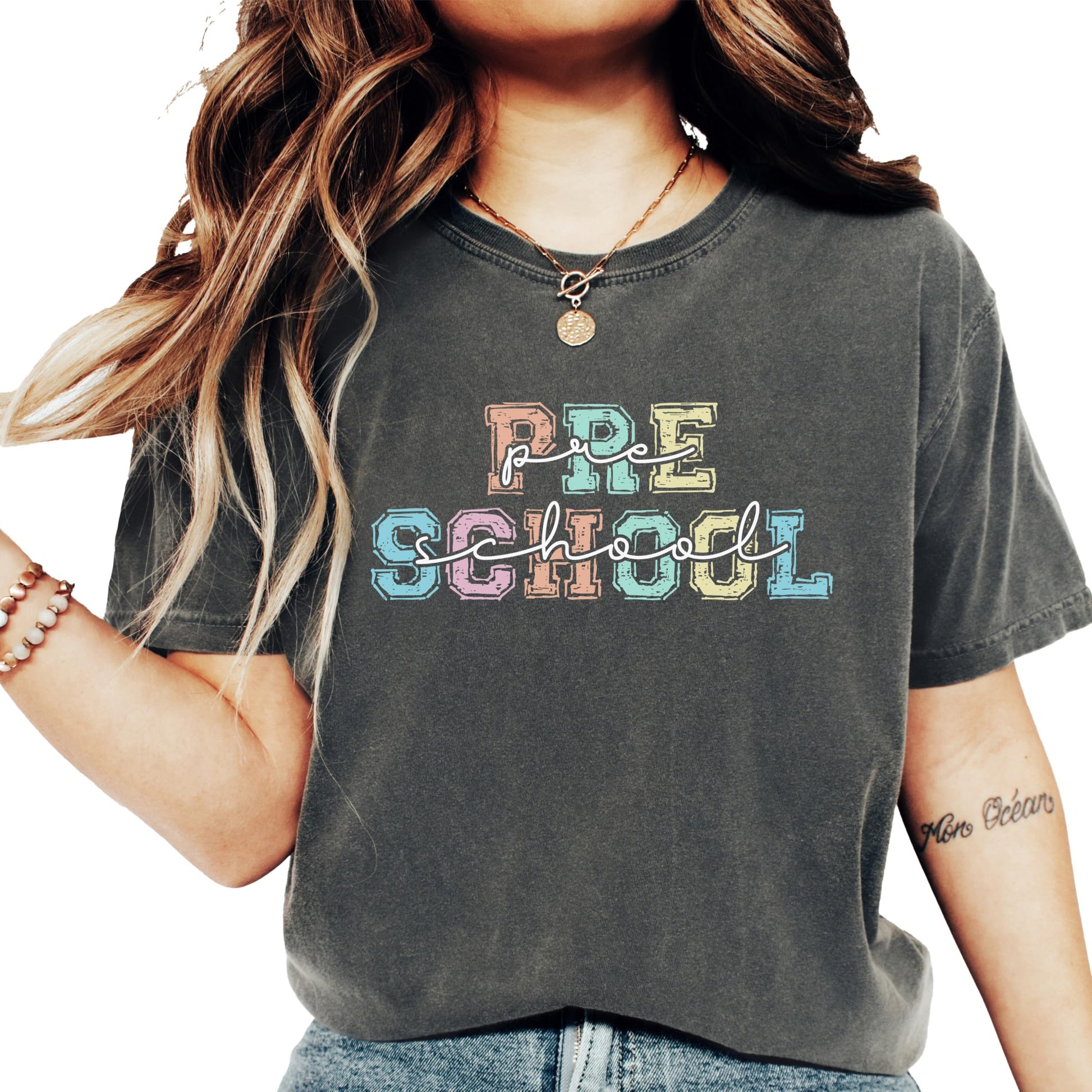 Women's white graphic tee with bold colorful 'Preschool' lettering, designed for preschool teachers
