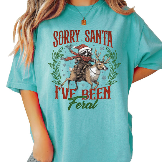 Sorry Santa I've Been Feral Christmas shirt laid flat showing full graphic design detail
