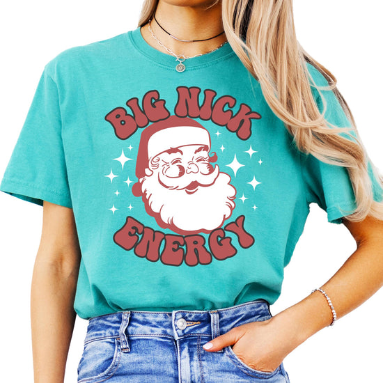 Close-up of Big Nick Energy jolly Santa graphic print on women's holiday tee