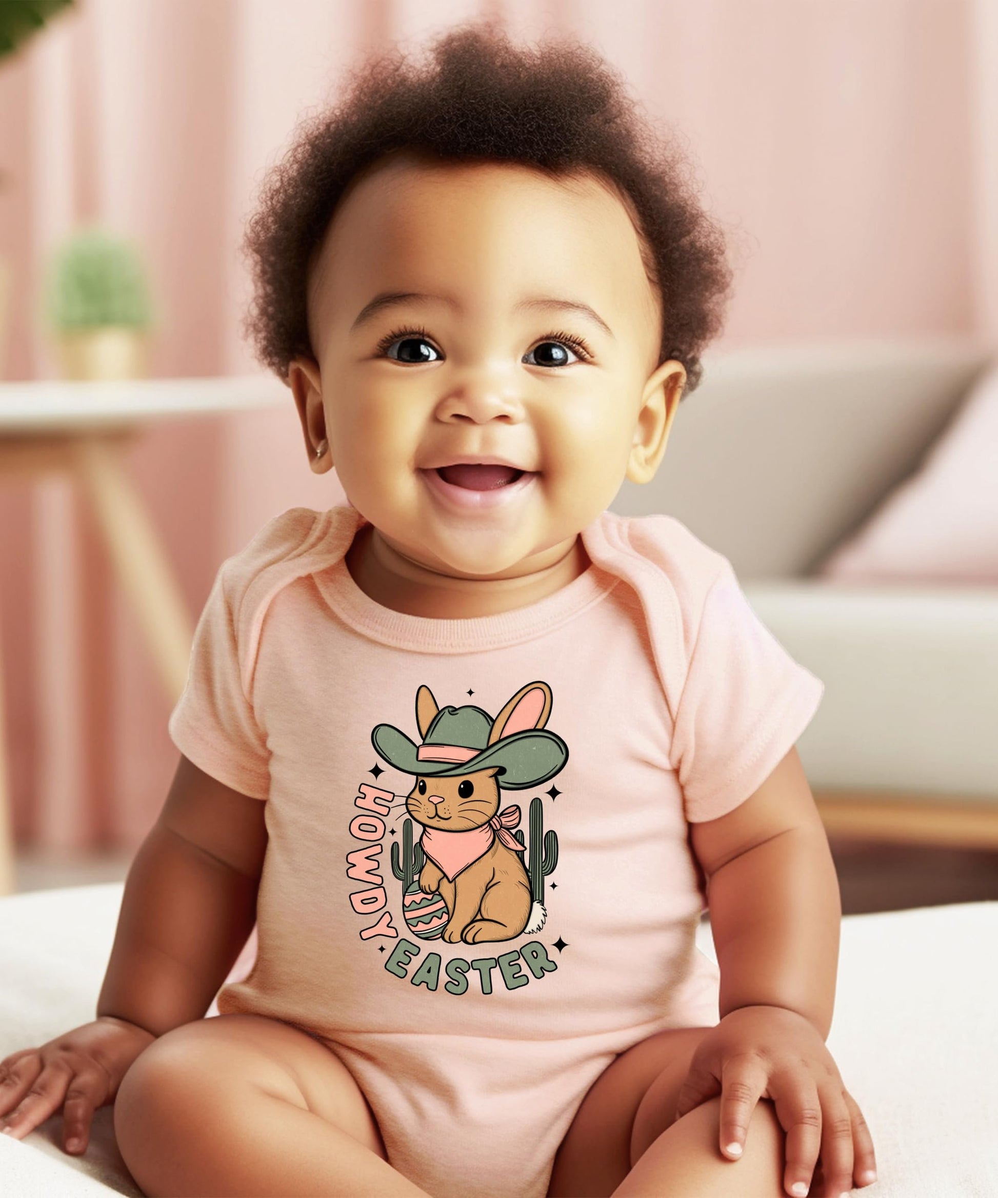 Close-up of howdy cowboy rabbit graphic print on peach infant bodysuit
