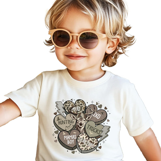 Detail shot of conversation hearts camo print on boys black Valentine's Day graphic tee