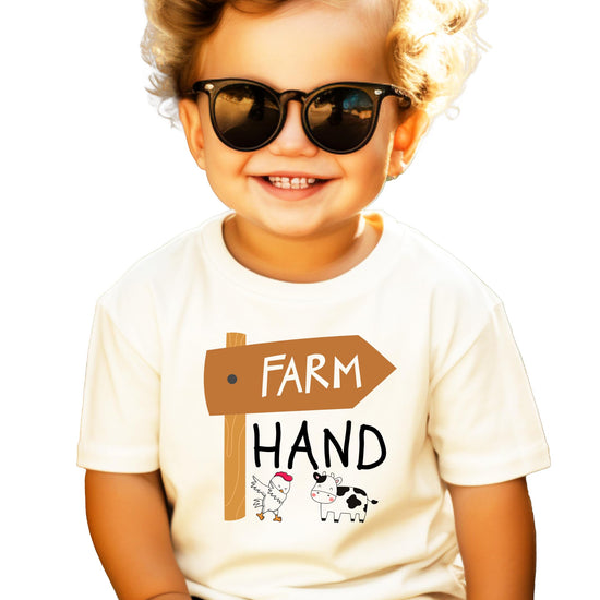 Close-up of farm hand graphic print with chicken and cow detail on kids natural shirt