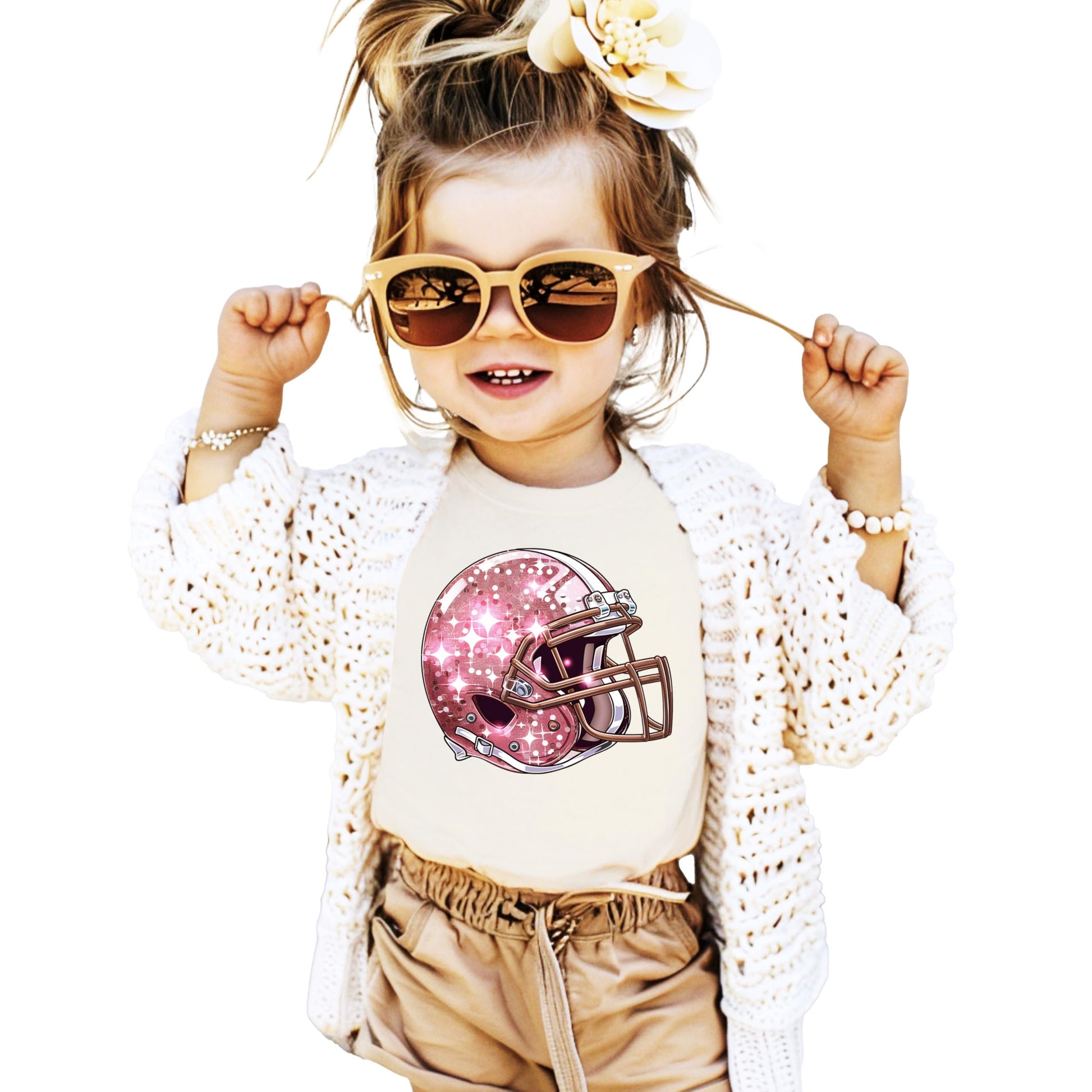 Front view of pink glitter football helmet shirt for girls on natural tee