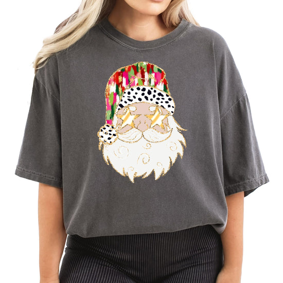 Flat lay of ivory women's Christmas shirt with funny painted Santa wearing gold sunglasses design