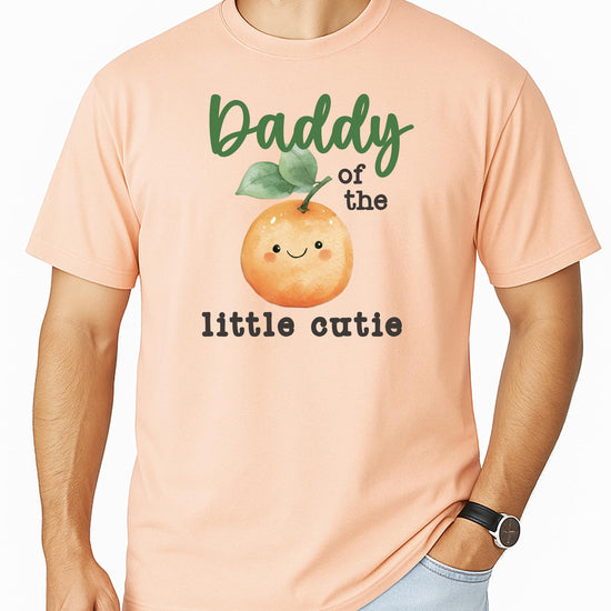 Baby wearing One Little Cutie peach orange birthday bodysuit, front view of graphic design