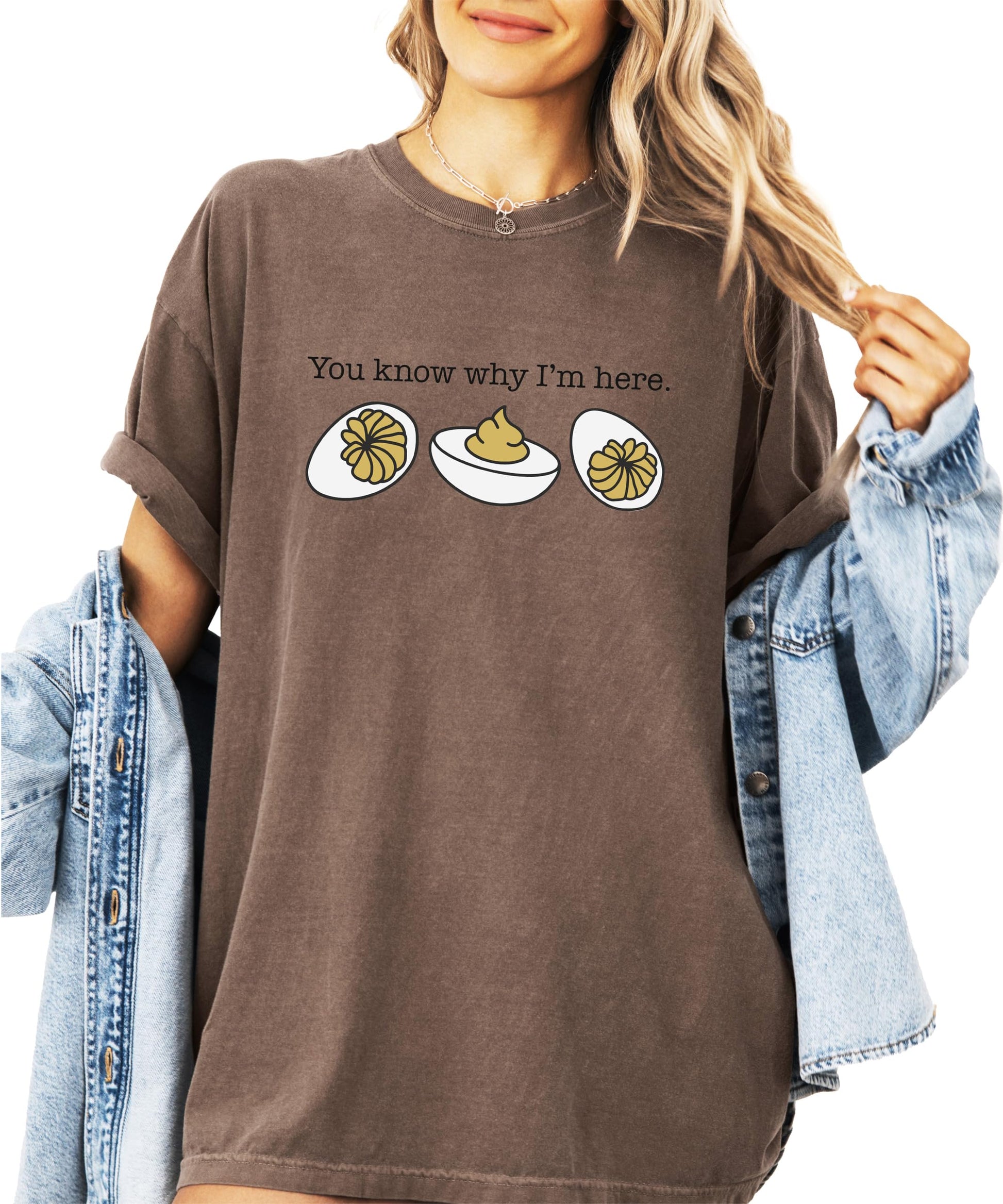 Close-up of deviled egg illustration with funny saying on brown t-shirt