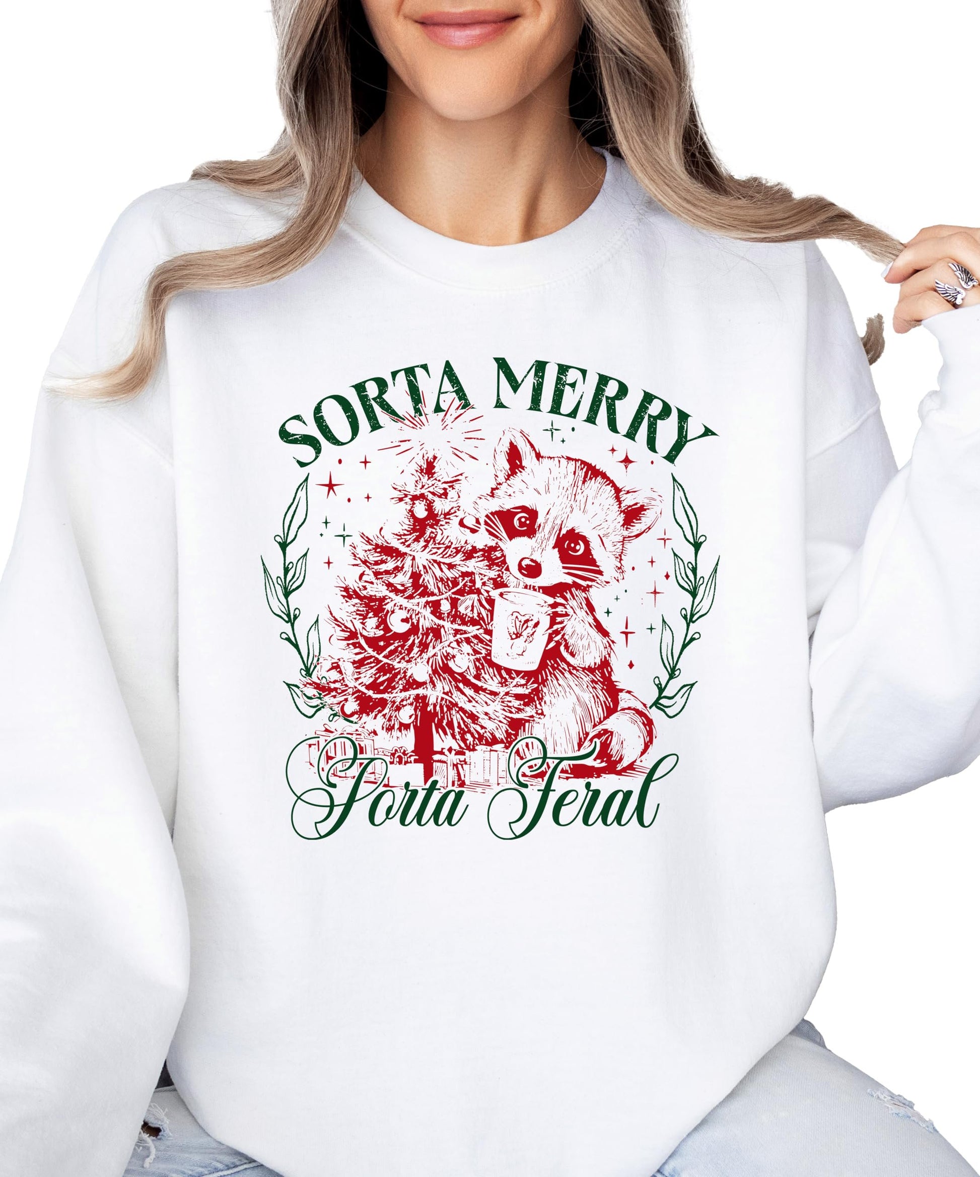 Close-up of Sorta Merry Sorta Feral raccoon Christmas tree graphic print on white sweatshirt