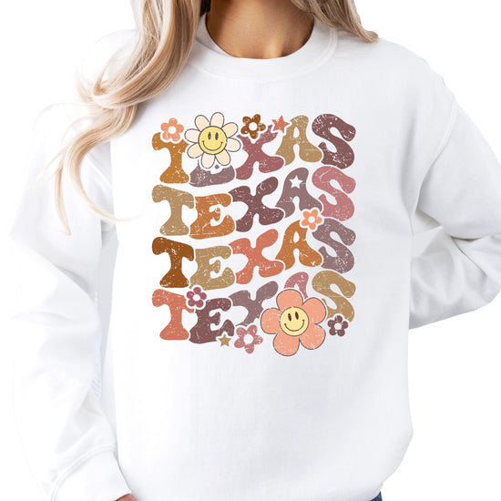 Woman wearing white Texas sports sweatshirt with colorful flower design